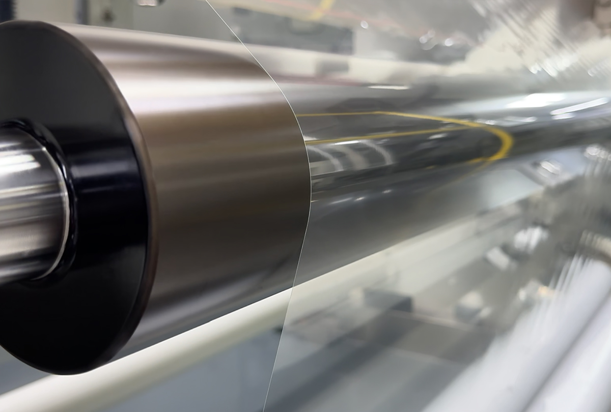 Transparent automotive film running across a precision production roller